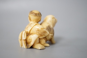 A Japanese ivory netsuke of a boy and puppy, Meiji period, unsigned, 4cm